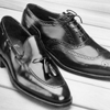 Black Men\'s Shoes on Wooden Deck  